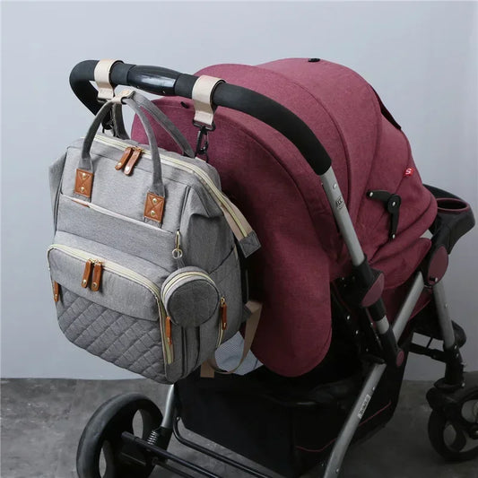 Mochila para mamá con cuna plegable